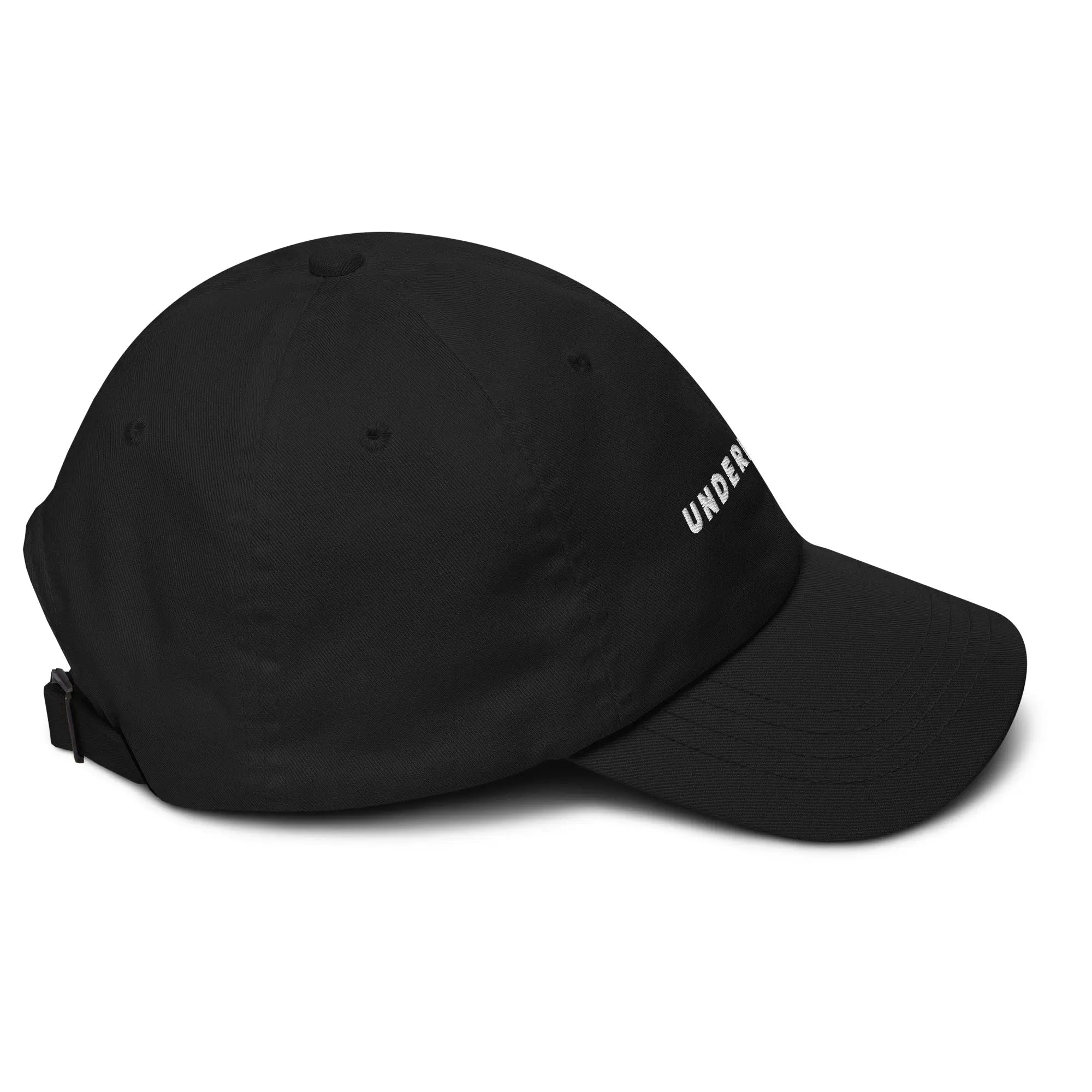 Right side view of product mockup of Black classic dad hat with white embroidered "UNDERBRUSH" logo centered on the front.