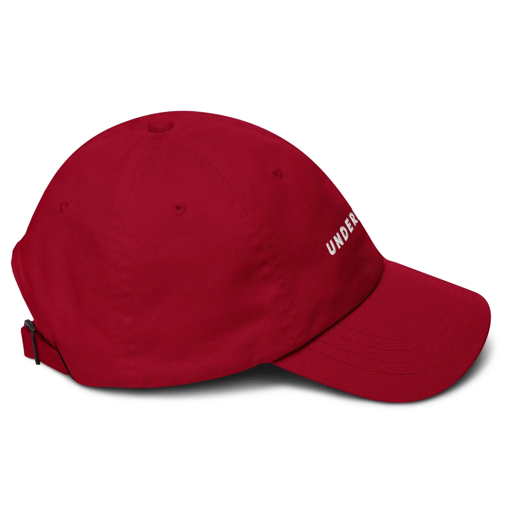 Right side view of product mockup of cranberry classic dad hat with white embroidered "UNDERBRUSH" logo centered on the front.