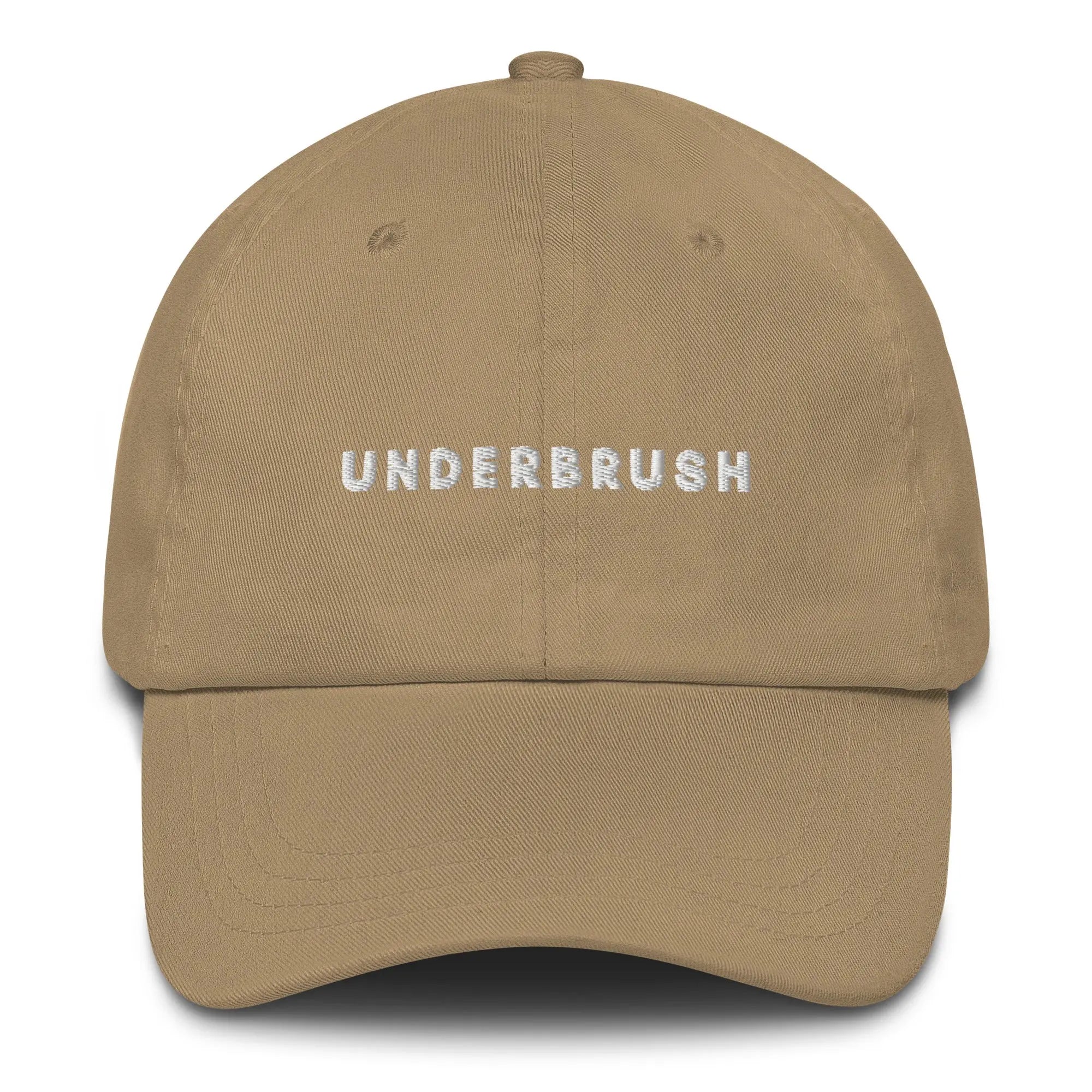 Frontal view of product mockup of khaki classic dad hat with white embroidered "UNDERBRUSH" logo centered on the front.