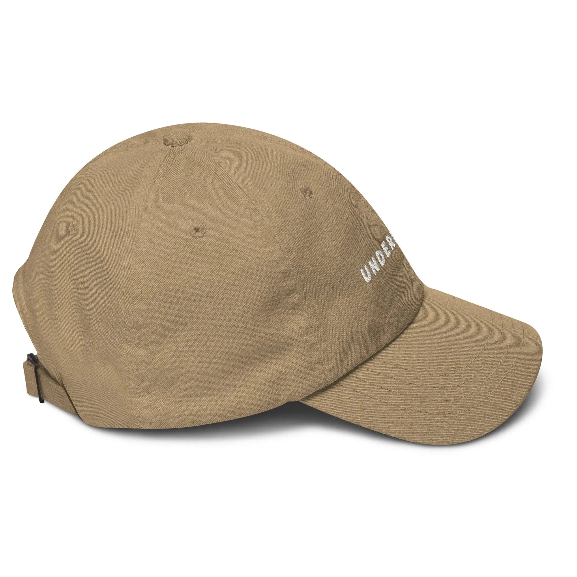Right side view of product mockup of khaki classic dad hat with white embroidered "UNDERBRUSH" logo centered on the front.