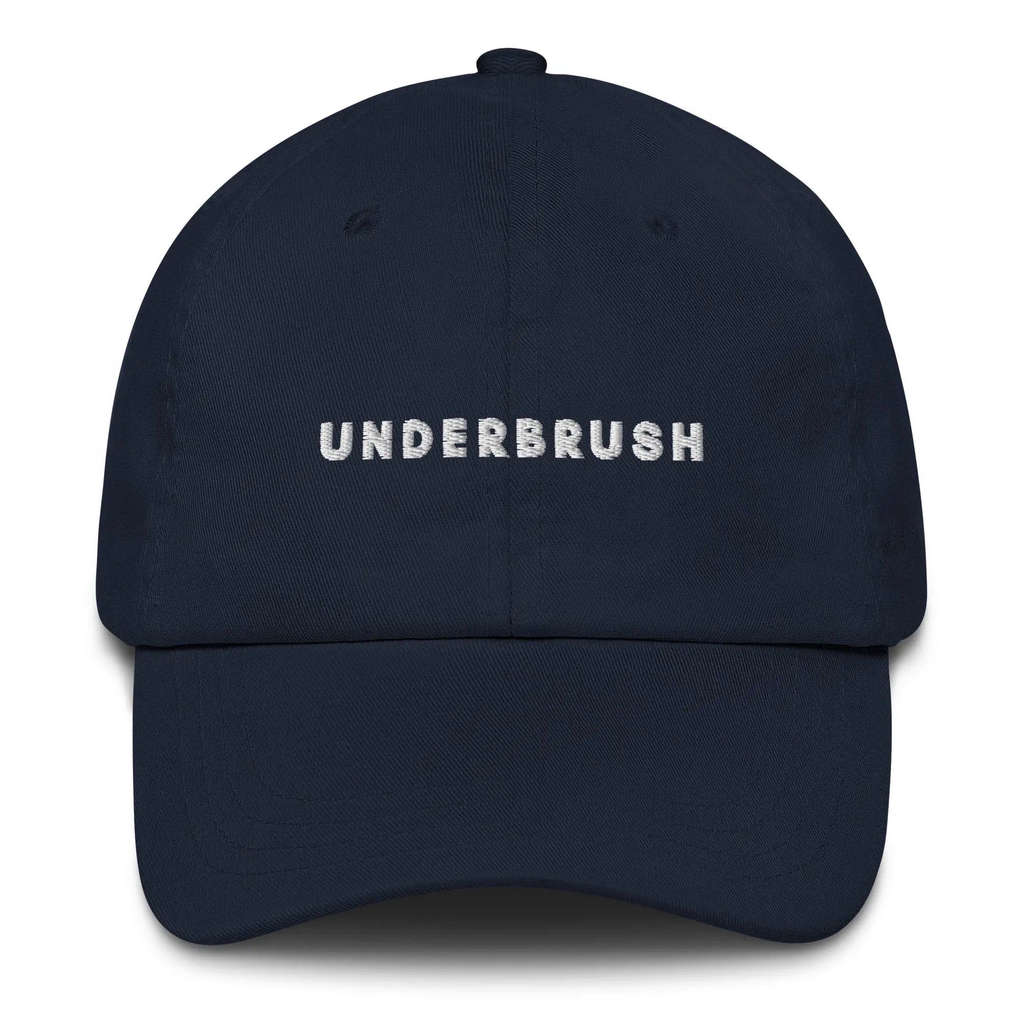 Frontal view of product mockup of navy classic dad hat with white embroidered "UNDERBRUSH" logo centered on the front.