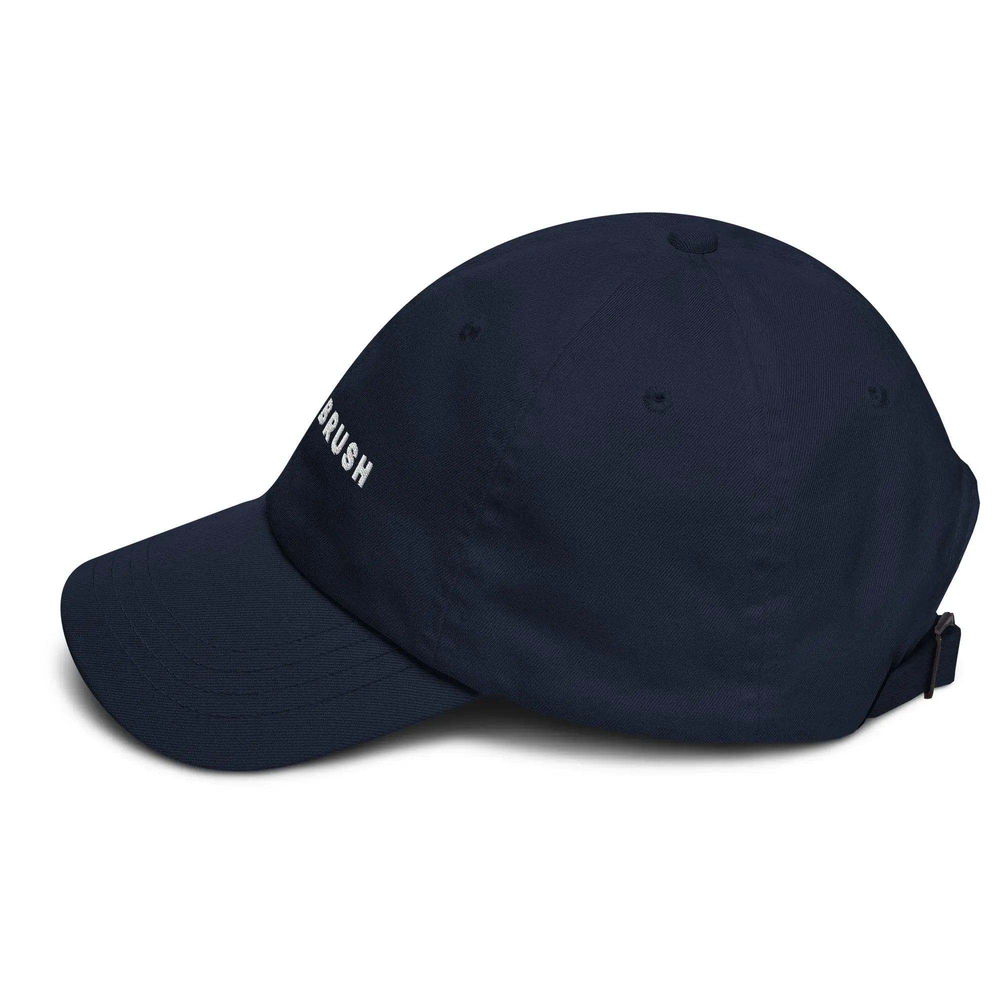 Left side view of product mockup of navy classic dad hat with white embroidered "UNDERBRUSH" logo centered on the front.