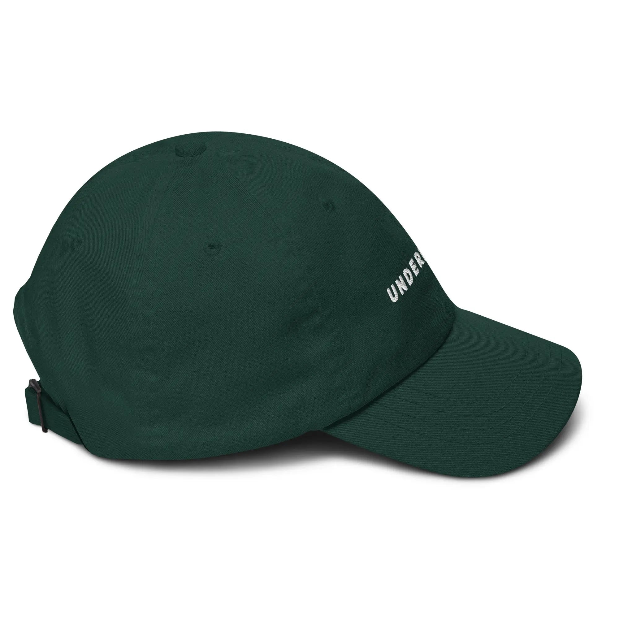 Right side view of product mockup of spruce classic dad hat with white embroidered "UNDERBRUSH" logo centered on the front.