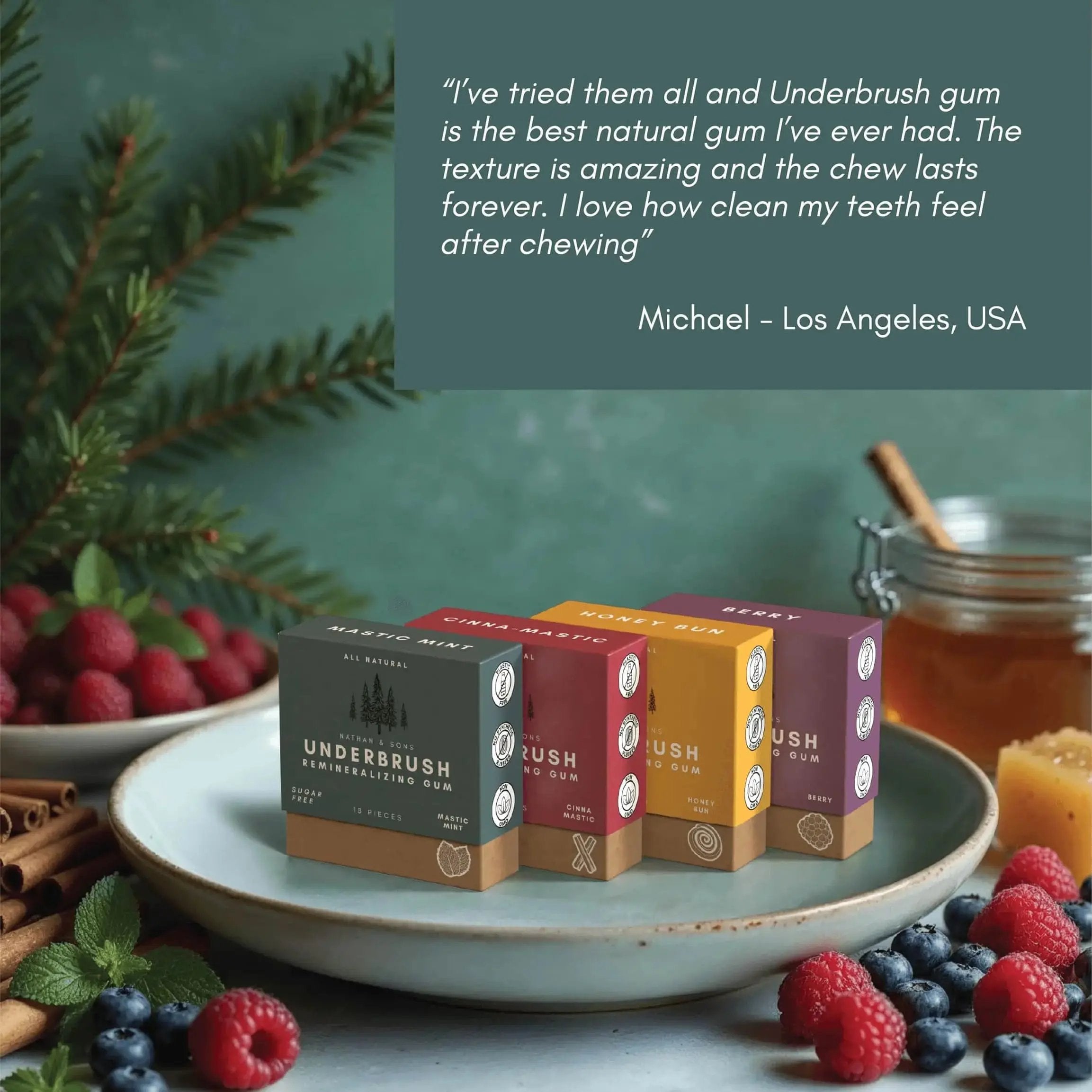 Customer review of Underbrush Remineralizing Gum, praising its natural ingredients, long-lasting chew, and teeth-cleaning benefits, with product boxes in Mastic Mint, Cinna Mastic, Honey Bun, and Berry flavors surrounded by fresh berries and honey.